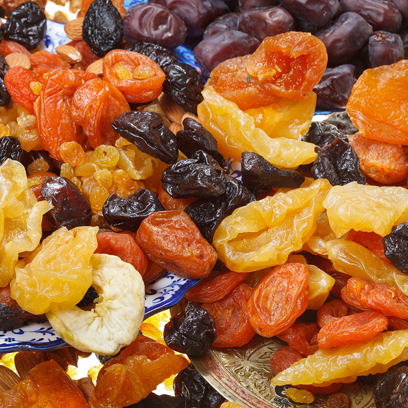 lot of dried sweet fruits on asian plates